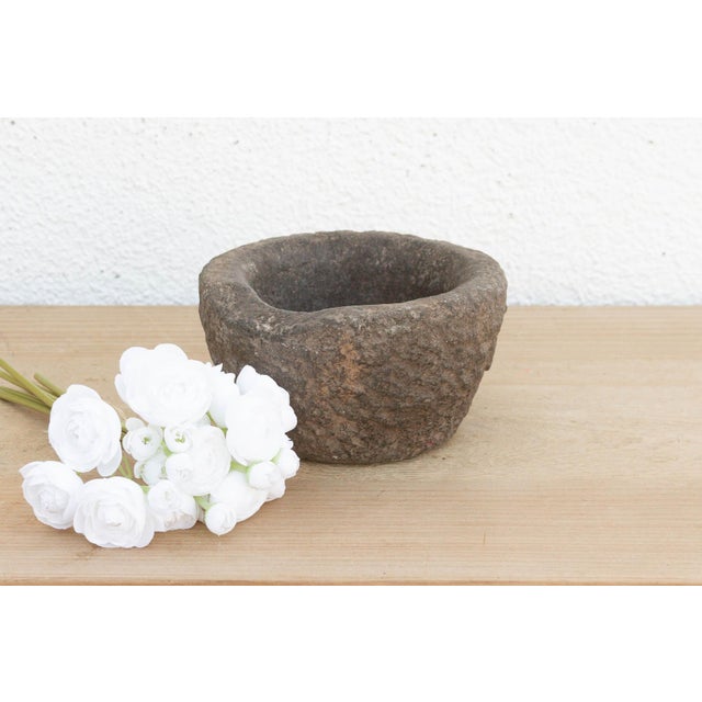 This heavy stone mortar is a relic of the "Old World" kitchen. Carved from a single block of solid granite, it was...