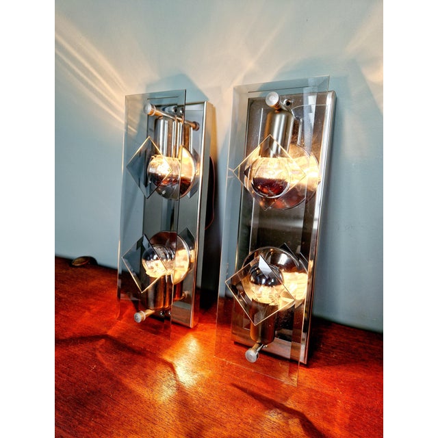 Pair of chrome-plated metal and smoked glass wall lights, produced by the german manufacturer siche (simon & schelle) in...
