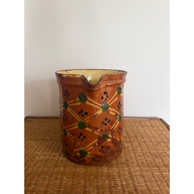 French Savoie Glazed Earthenware Pitcher decorated with hand-trailed yellow slip lattice, green dot rosettes and manganese...