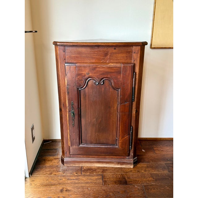 A beautifully preserved antique corner cabinet, likely French in origin and dating to the late 18th or early 19th century....