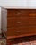 A petite Danish chest of drawers in the Art Deco tradition, produced in the 1950s with carved legs and original brass...