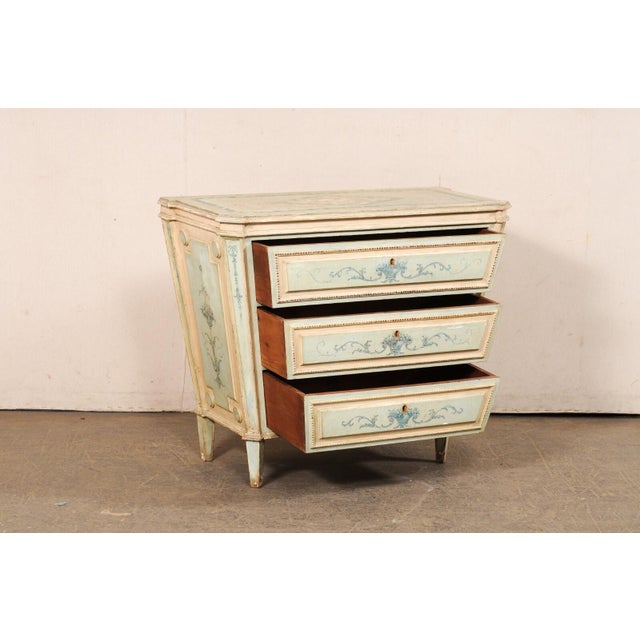 An Italian Venetian chest, with whimsical trapezoid shape and hand painted design, from the early 20th century. This...