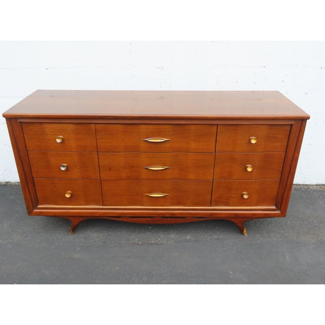 This magnificent Dresser is made of wood, walnut, and veneer. This wonderful Dresser is an excellent example of the Mid-...