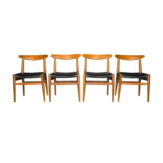 An exceptional set of four original ‘W2’ model chairs, designed by Hans J. Wegner, Denmark, circa 1960’s. The teak frames...