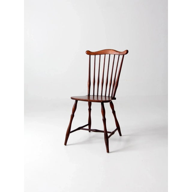 An antique late 19th century fan-back Windsor chair with turned splayed legs and a mustache-shaped top rail. The...