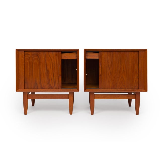 A rare find, this stunning pair of Danish Mid-Century teak nightstands was designed by Svend Åge Madsen for Falster...