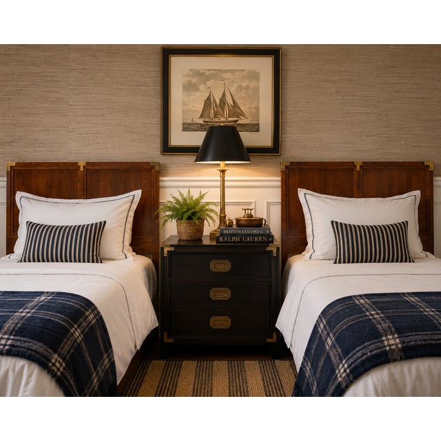 A refined pair of vintage twin headboards by Henredon featuring richly toned walnut veneers accented with brass campaign-...