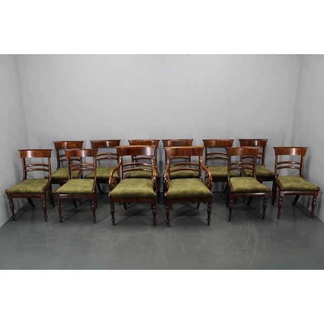 An exceptional French Art Deco dining chair set from the 1930s, comprising ten dining chairs and two armchairs, crafted...