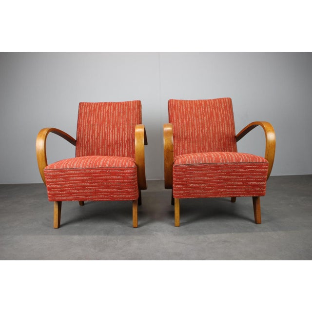 A striking pair of mid-century lounge armchairs attributed to Jindřich Halabala, produced in Czechoslovakia during the...