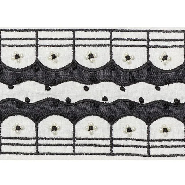 A tour de force of dressmaker details, this exquisite velvet tape is embellished with pearls, appliqué and hand...