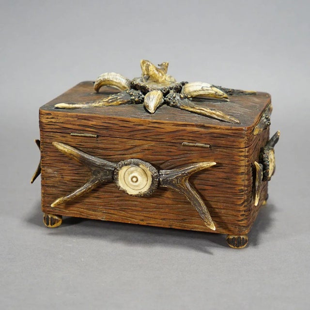 Wooden Black Forest Casket with Antlers Decoration circa 1900s A marvelous rustic wooden casket or cigar box. It is made...