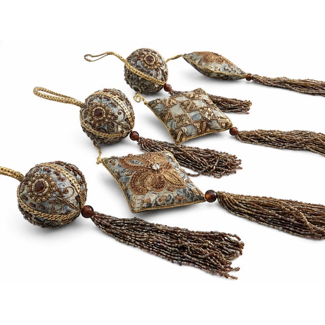An elegant set of six decorative Christmas ornaments in a sophisticated palette of antique gold, taupe, bronze, and soft...