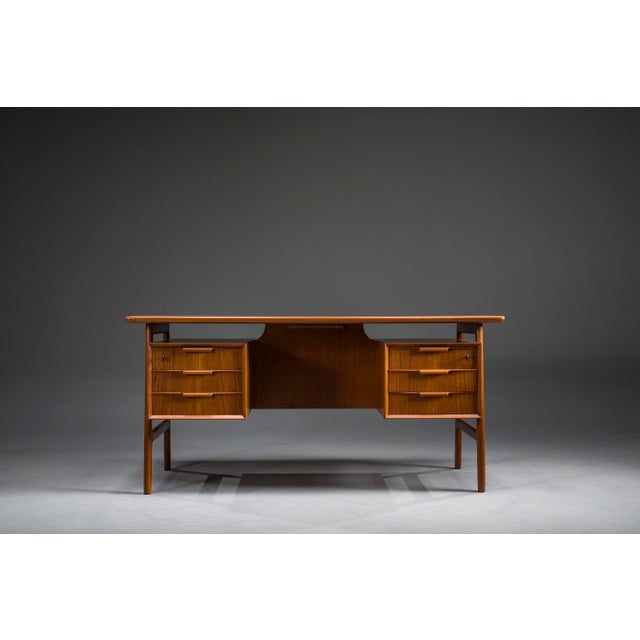 Model 75 Teak Desk by Omann Jun Møbelfabrik, 1960s This iconic Danish Modern desk, produced by the renowned Omann Jun...