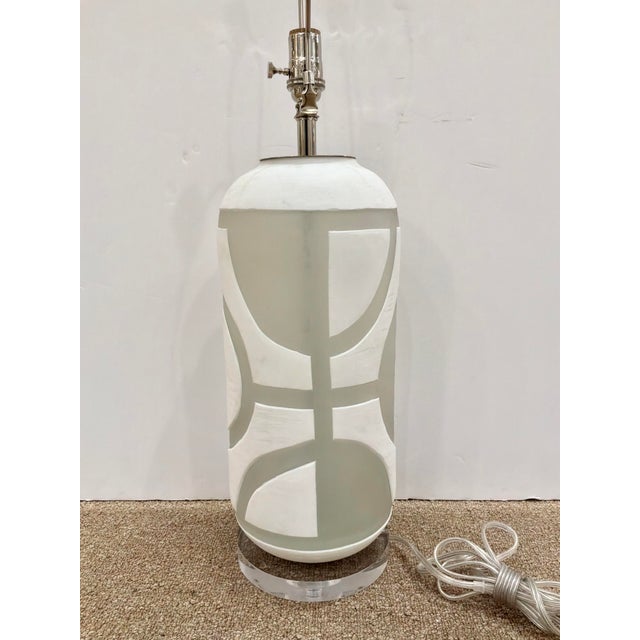 Modern Currey & Co Carved Glass Lamp. Frosted / White geometric design on round acrylic base. Showroom floor sample.