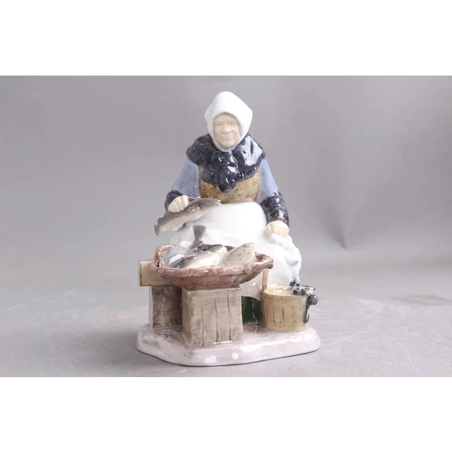 B&G figure 2233 woman from Skovshoved selling fish at Gammel beach 1st sort. Design by Axel Locher and execution in...