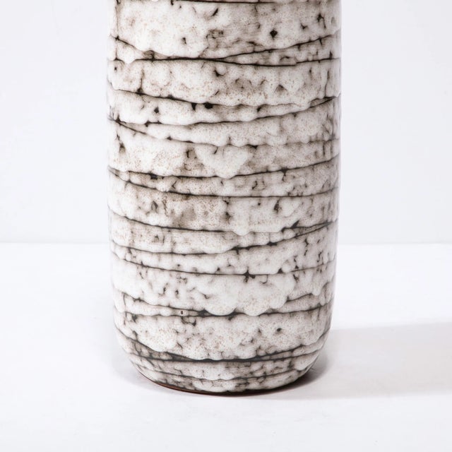 This Mid-Century Modernist Horizontally Striated Ceramic Vase is a beautiful example of Post War European Ceramics,...