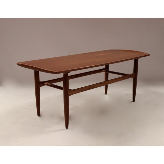 This teak coffee table was manufactured by Jason Furniture, Denmark, during the 1960s. Imprinted by Maker,This piece has...