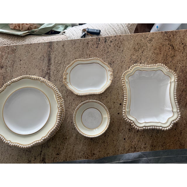 6 dinner plates, 6 saucers, 1 small platter and a serving dish- gorgeous and gold encrusted. Used but still a lot of life...
