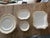 6 dinner plates, 6 saucers, 1 small platter and a serving dish- gorgeous and gold encrusted. Used but still a lot of life...