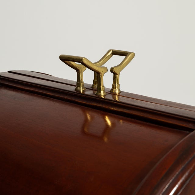 A 20th century English high bar table crafted in wood, featuring a tall and narrow profile supported by a structured base....