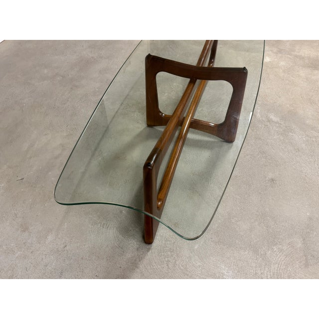 A mid century modern walnut ribbon coffee table designed by Adrian Pearsall for Craft Associates. Minor light scratches in...