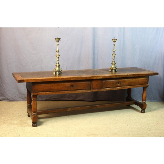 Large oak table or side table resting on four baluster legs joined by a stretcher. This table features two sliding drawers...