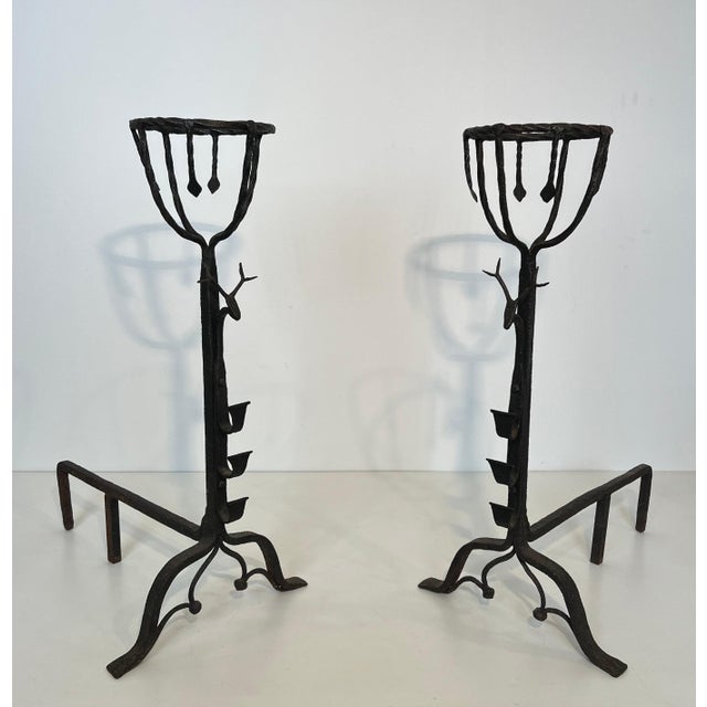 This very fine, rare, interesting, and important pair of andirons is made of wrought iron. They are decorated with...