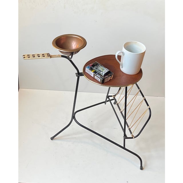 Rare small light-weight hybrid side table made from bend and welded string iron in black paint. It features a guitar pick...