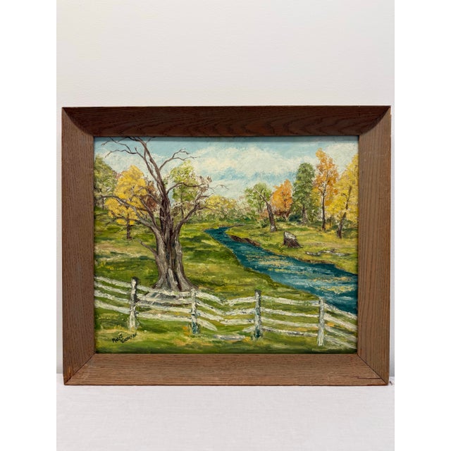 A charming signed original oil painting depicting a peaceful pastoral landscape with a winding blue stream, weathered...