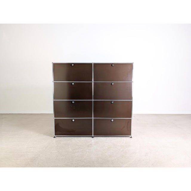 Beautiful brown USM Haller filing cabinet (2x4) for sale. The cabinet features eight compartments, each with a bottom-...