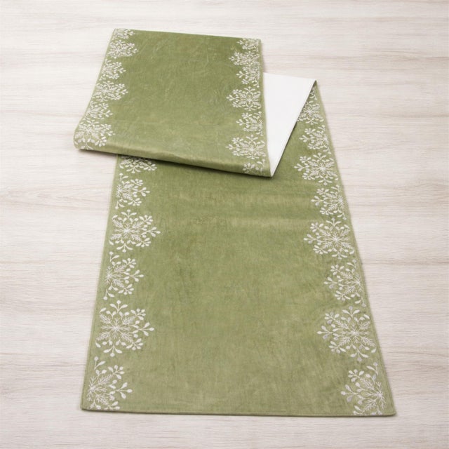 Bring a soft winter glow to your holiday table with this sage snowflake table runner, a beautiful blend of seasonal charm...