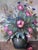 This original vintage oil painting from the 1960s shows a vibrant bouquet of wildflowers arranged in a ceramic vase....