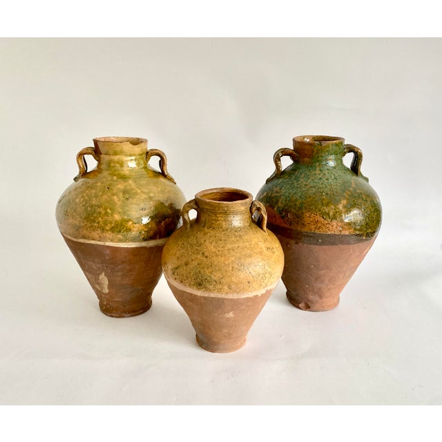 Vintage glazed terracotta Turkish oil jug with handles. Rustic with the charm of handmade pottery and aged patina. Mouth...
