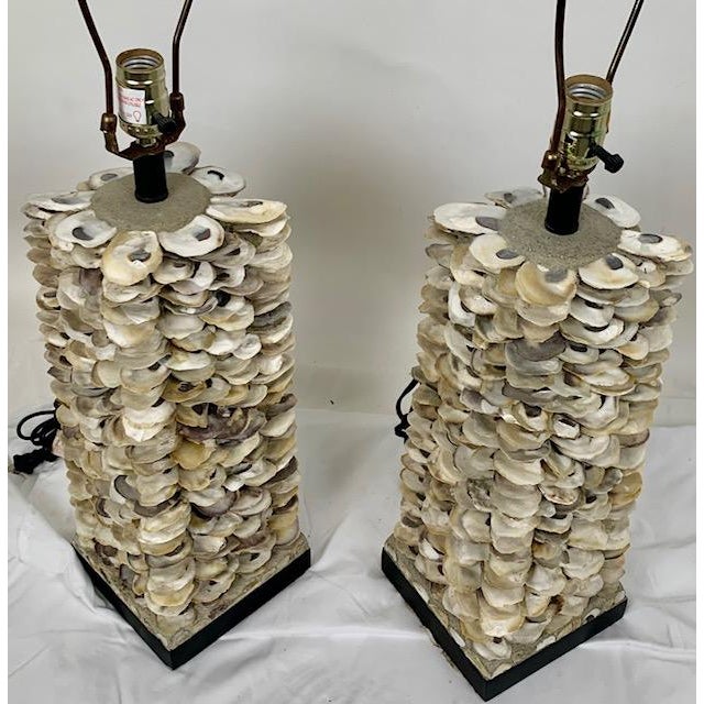 Bold and sculptural, this pair of Villamare table lamps by Currey & Co. showcases natural oyster shells meticulously...