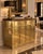 Striking 1970s brass and burl wood bar cabinet attributed to Mastercraft, featuring the bold material contrast and refined...