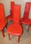 Designer chairs, produced in the 1980s. fully upholstered in ferrari red leather with stitched seams and black polished...