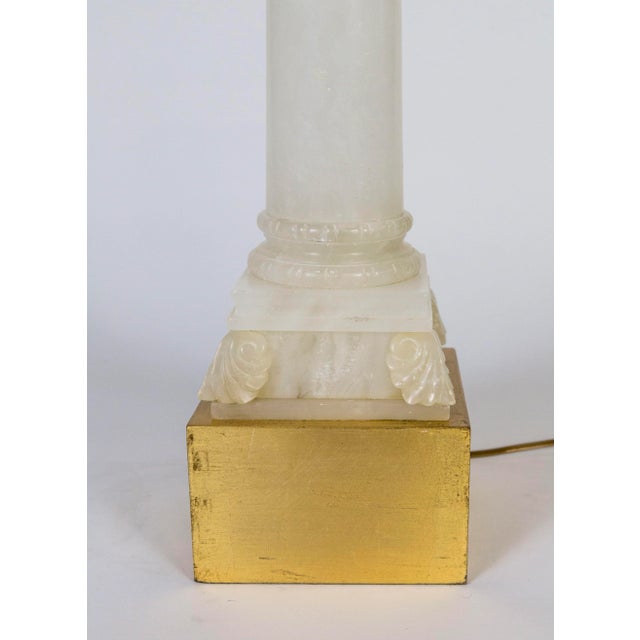 A gorgeous, polished, alabaster lamp in the form of a column with an acanthus leaf adorned capital. With an elevated,...
