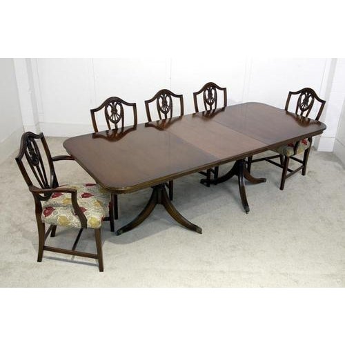 You are viewing an elegant Regency style dining table and matching Hepplewhite chairs The table top has softly rounded...