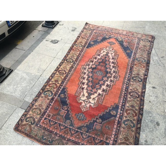 This is a vintage Turkish Oushak rug from the 1960s. The piece was hand-knotted.