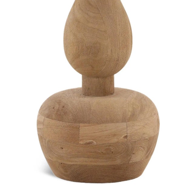 Elegant contemporary hourglass style mango wood base table lamp with white silk shade. Natural wood finish which will vary...