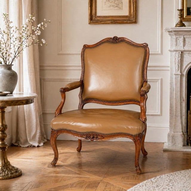 LOUIS XV CARVED AND LEATHER UPHOLSTERED FAUTEUIL France, Provincial Circa late 18th century, unmarked 37 7/8" H x 26 1/4"...