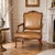 LOUIS XV CARVED AND LEATHER UPHOLSTERED FAUTEUIL France, Provincial Circa late 18th century, unmarked 37 7/8" H x 26 1/4"...