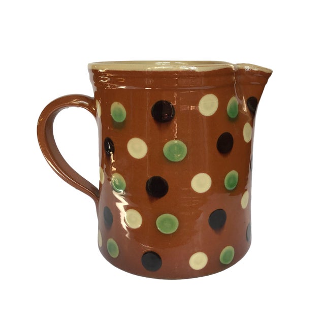 A charming hand-crafted pottery pitcher by acclaimed French ceramicist Jean-Christophe Hermann, featuring the signature...