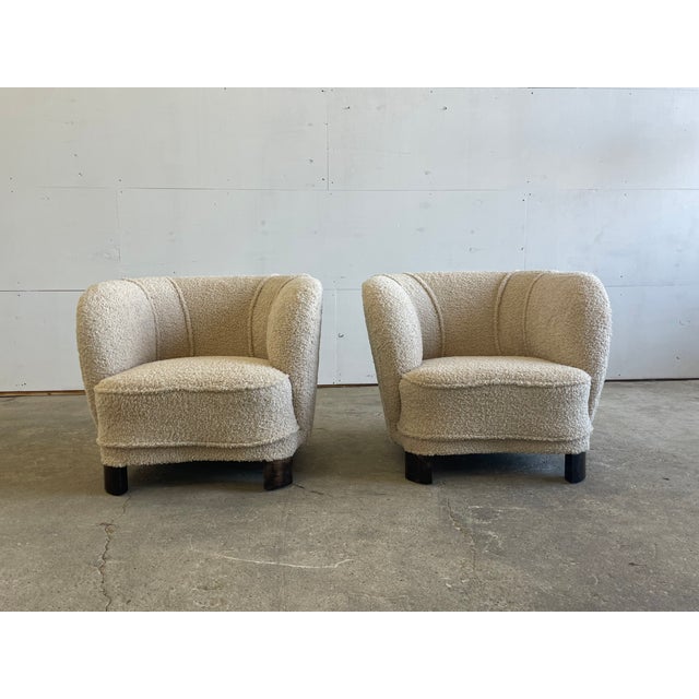 A charming pair of Danish club chairs from the 1940s, showcasing the soft, inviting curves characteristic of early...