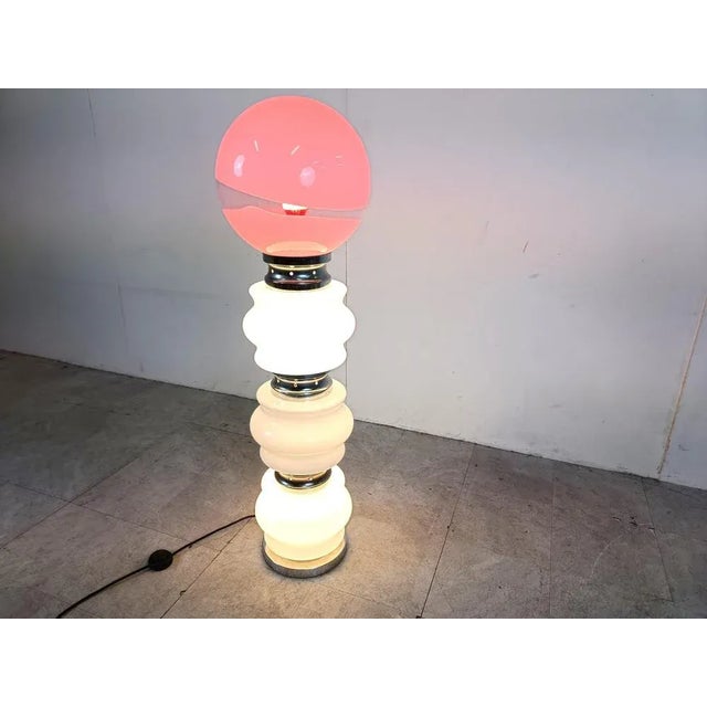 Mid century floor lamp consisting of three white murano glass parts and a globe glass lamp shade. In between the glass...