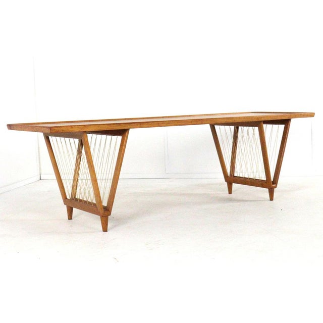 This vintage mid-century modern coffee table is a beautiful example of how functional design and artistic flair can go...
