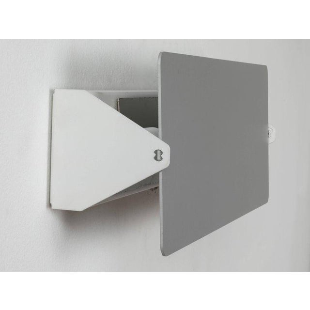 Charlotte Perriand 'Applique Á Volet Pivotant' wall light in natural aluminum. A clean and iconic design executed in...