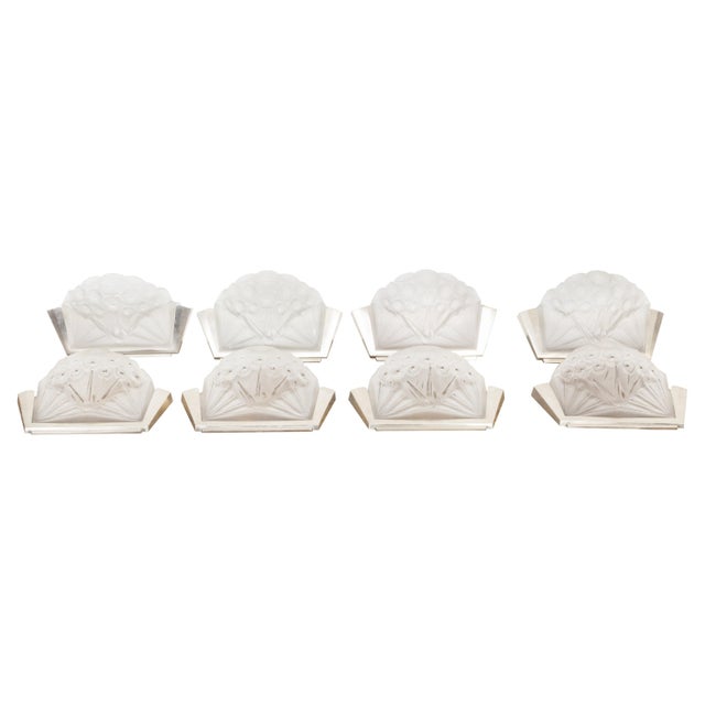 A pair of French Art Deco period molded glass wall sconces from the early 20th century with silver metal mount and...