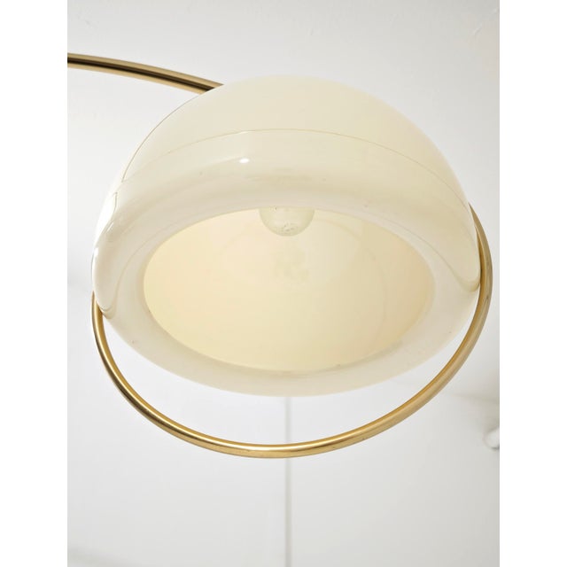 An iconic floor lamp with an extendable arc, designed by the renowned Italian designer Goffredo Reggiani for his company...