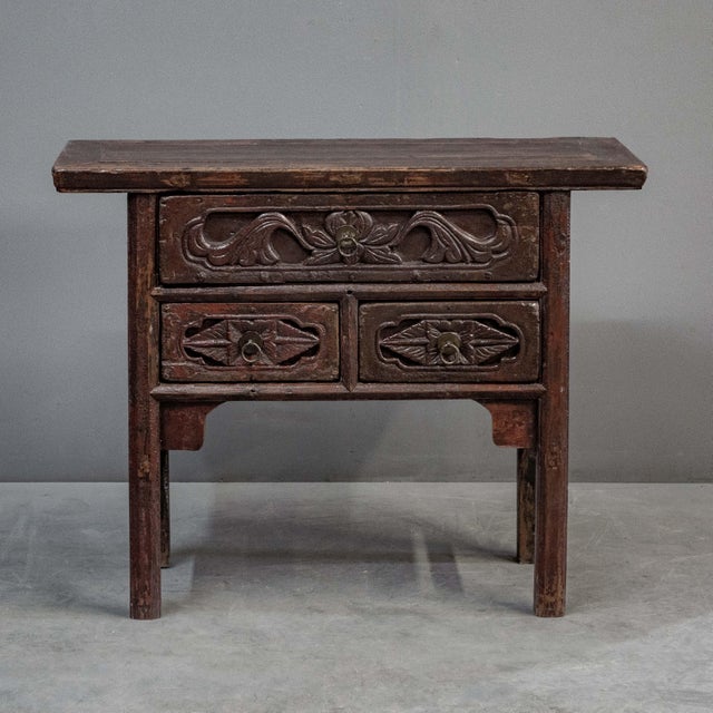 Antique intricately carved, dark red & lacquered Chinese altar table which could serve as a side or console table. Three...